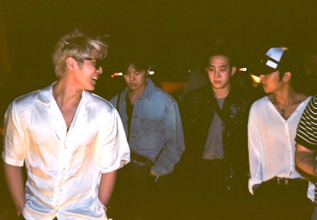 The Rose band members walking through Coachella at night. Photo by Richard Hama